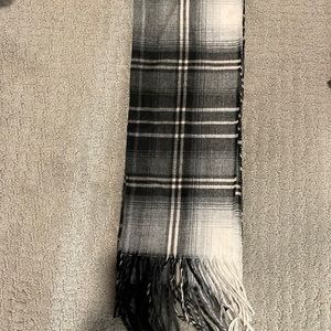 Two winter scarves. One black and white, and the other blue and pink.